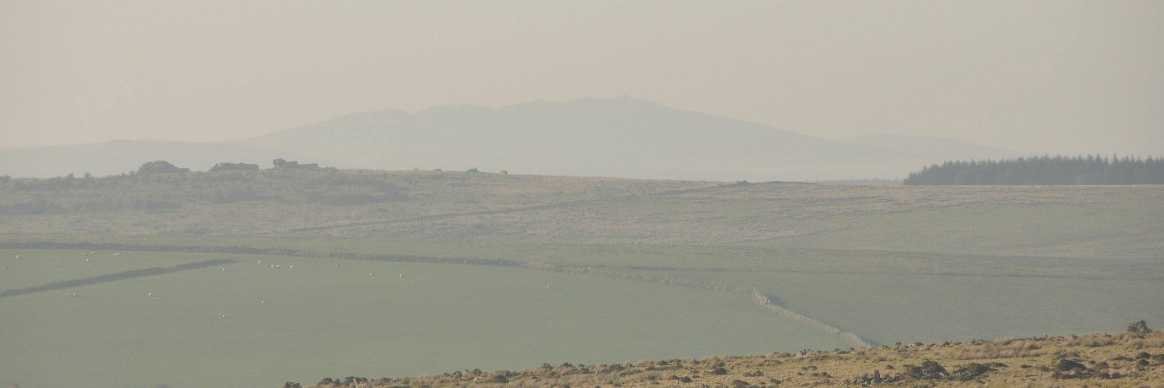 Rough Tor on Bodmin Moor — granite tor rising from open moorland under a wide Cornish sky.