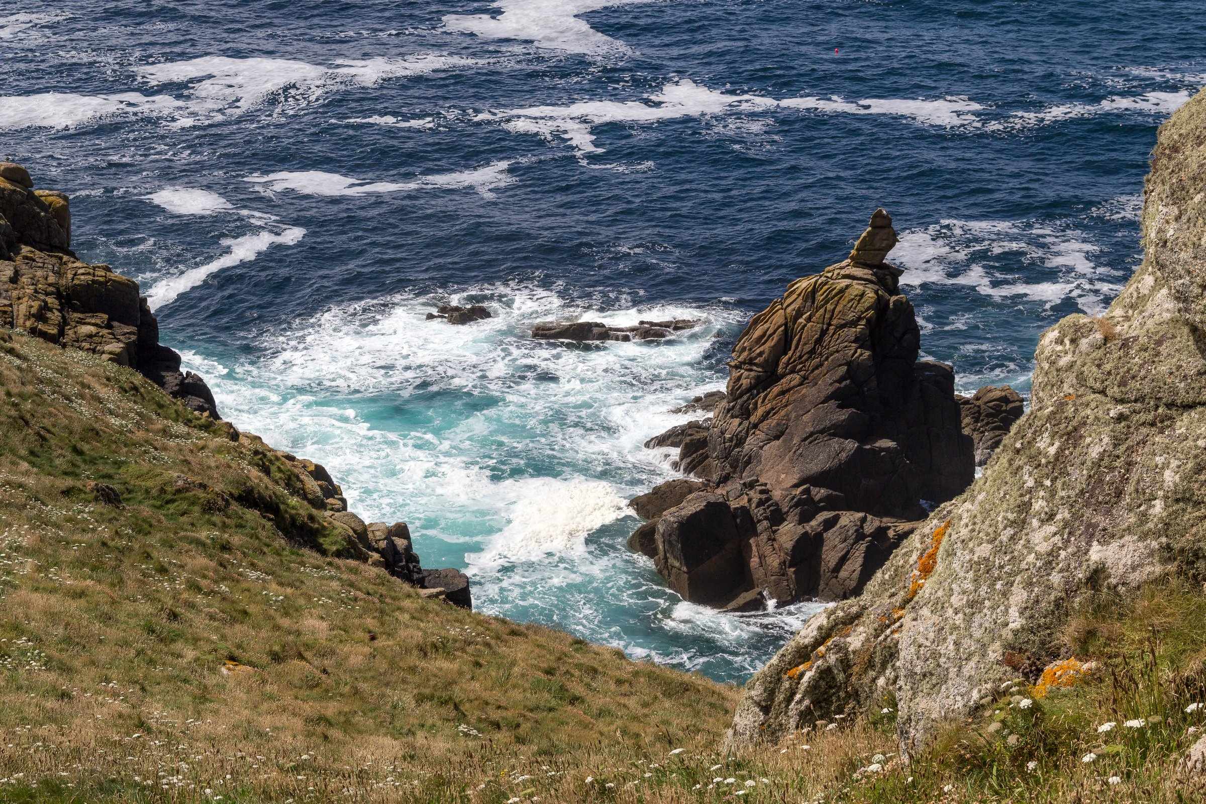 The South West Coast Path winding across open clifftop above the Atlantic near Land’s End.