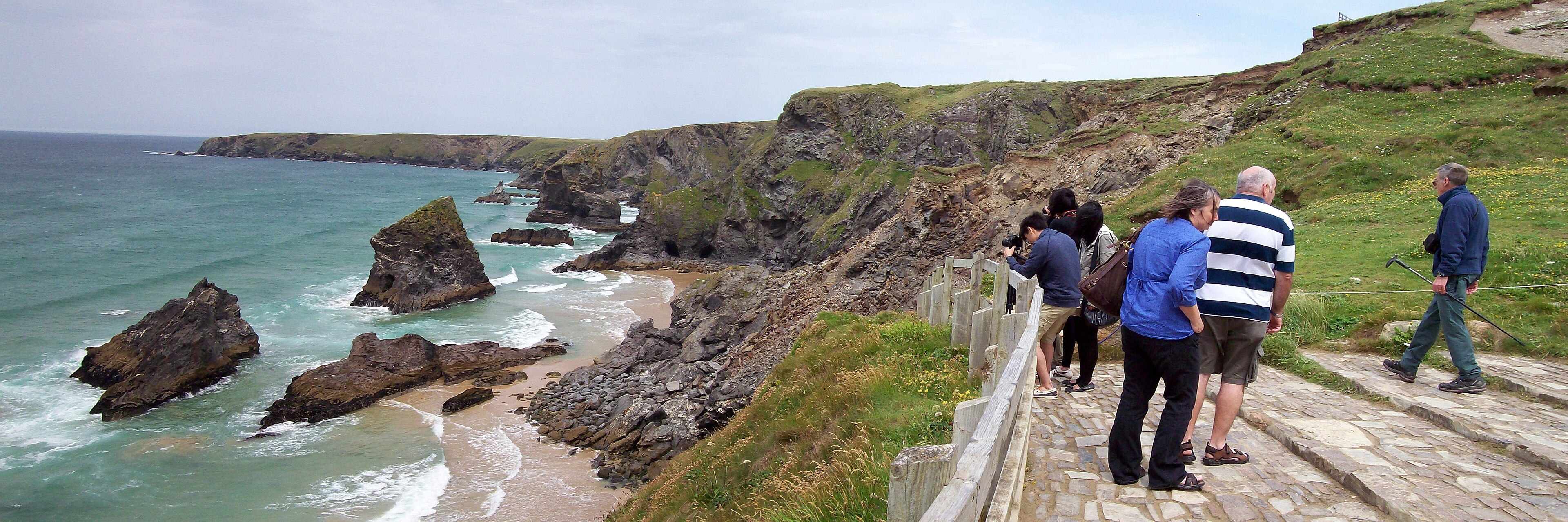 Bedruthan Steps on the north Cornwall coast — dramatic rock stacks and moody winter skies.
