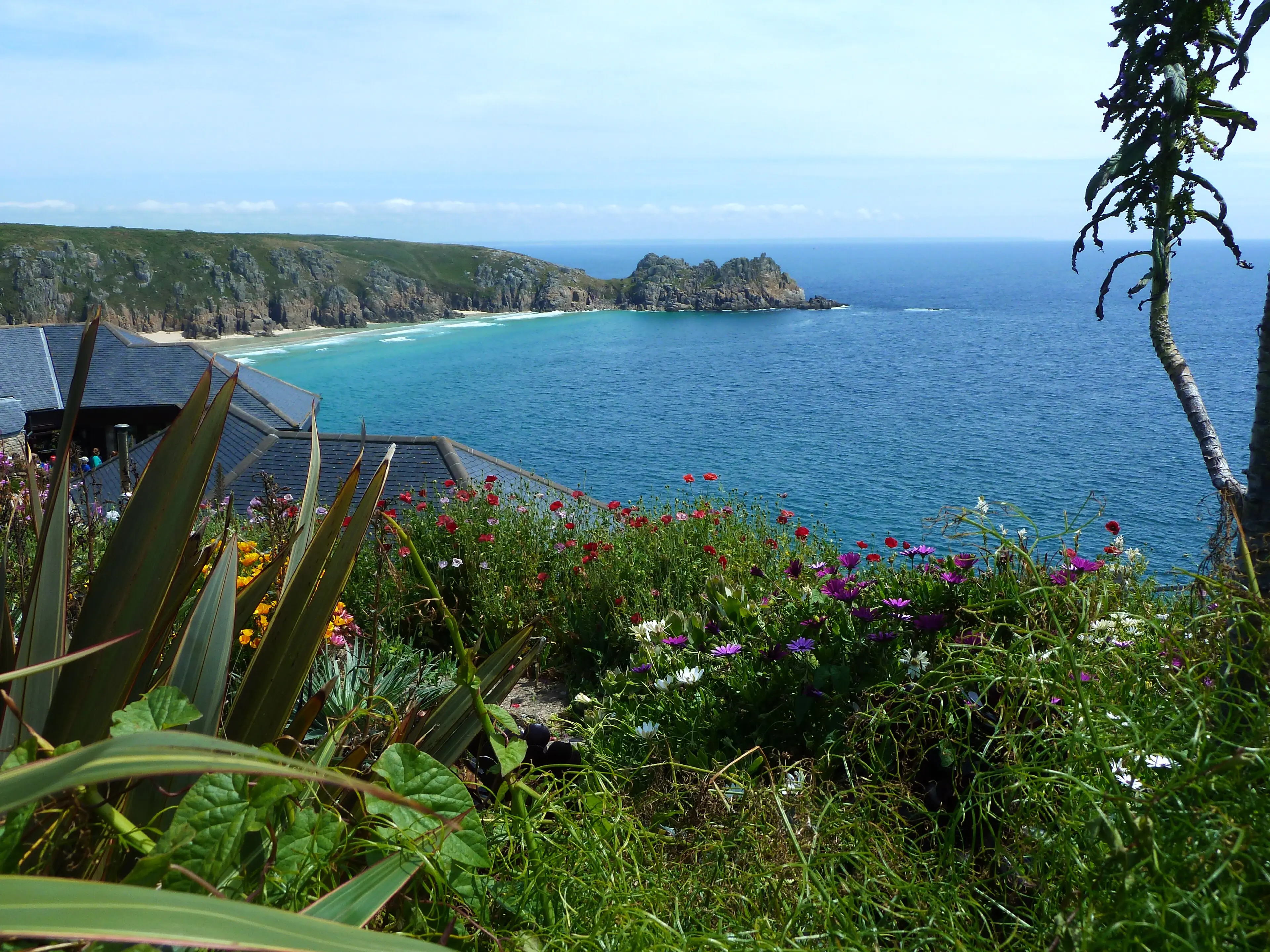 The Minack Theatre — an open-air amphitheatre carved into the granite cliffs above Porthcurno, with the Atlantic as backdrop.