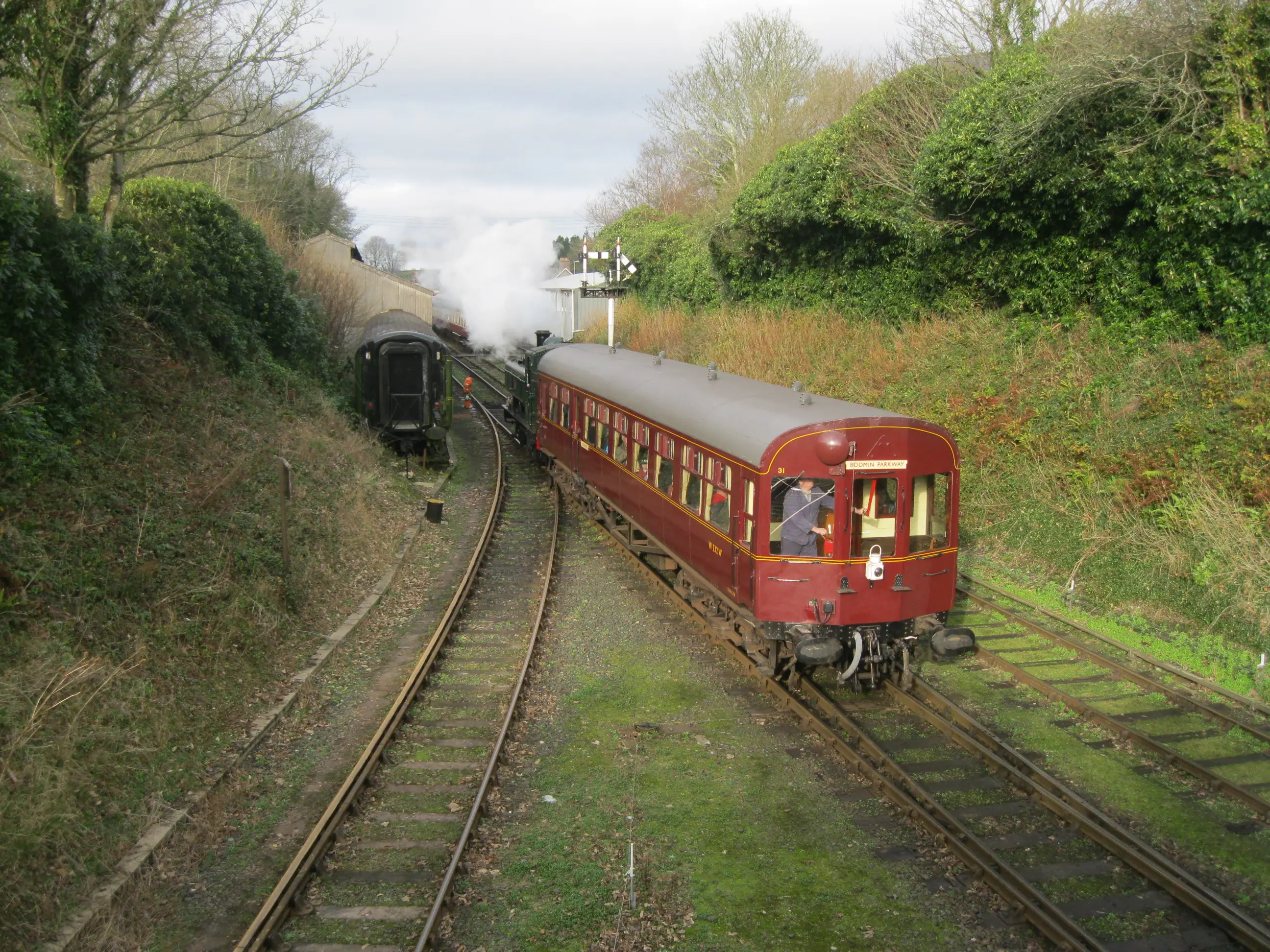 A GWR pannier tank locomotive with autocoach on the Bodmin & Wenford Railway.