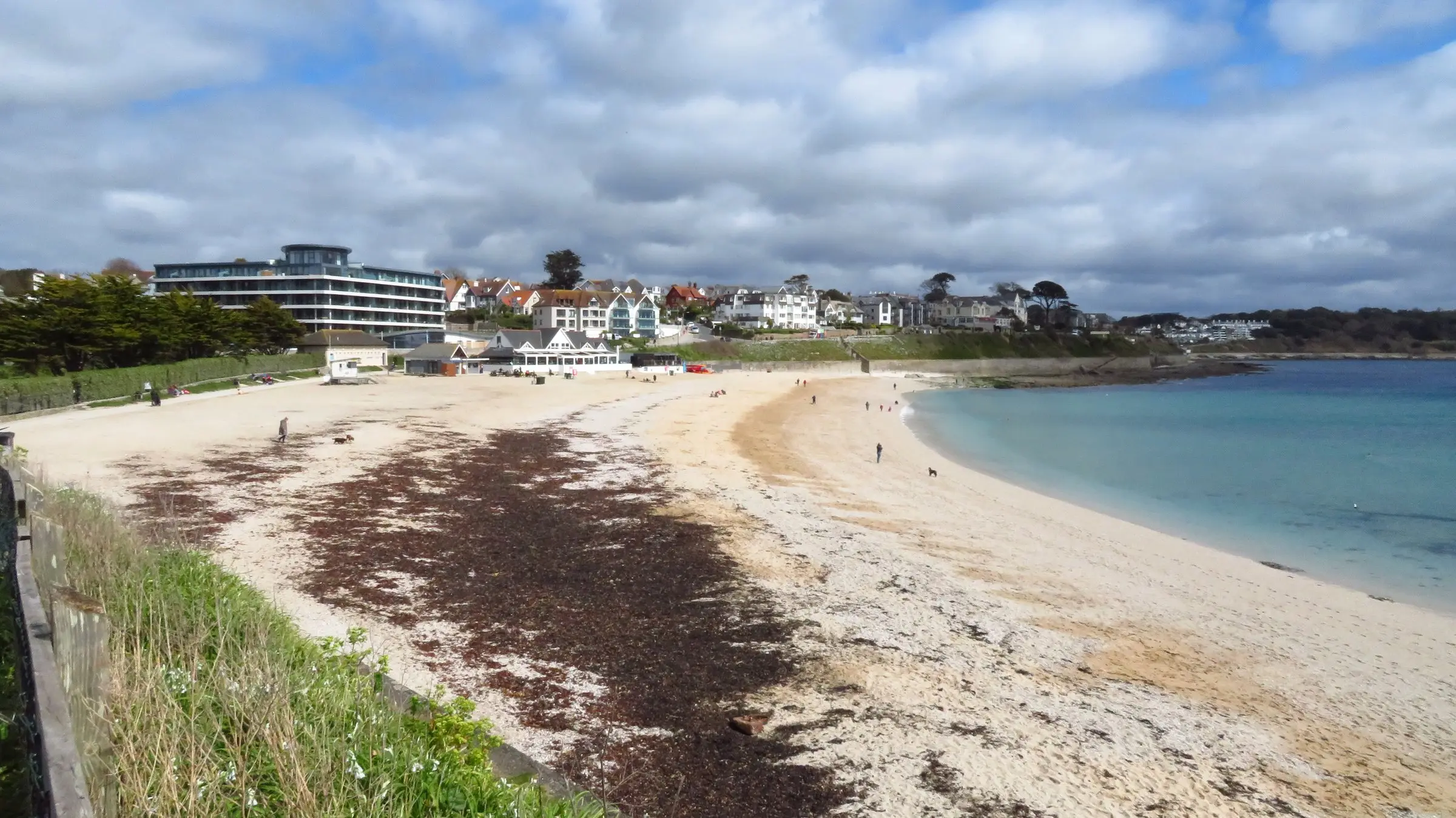 Swanpool Beach, Falmouth — wide sandy bay with headland and calm sea.