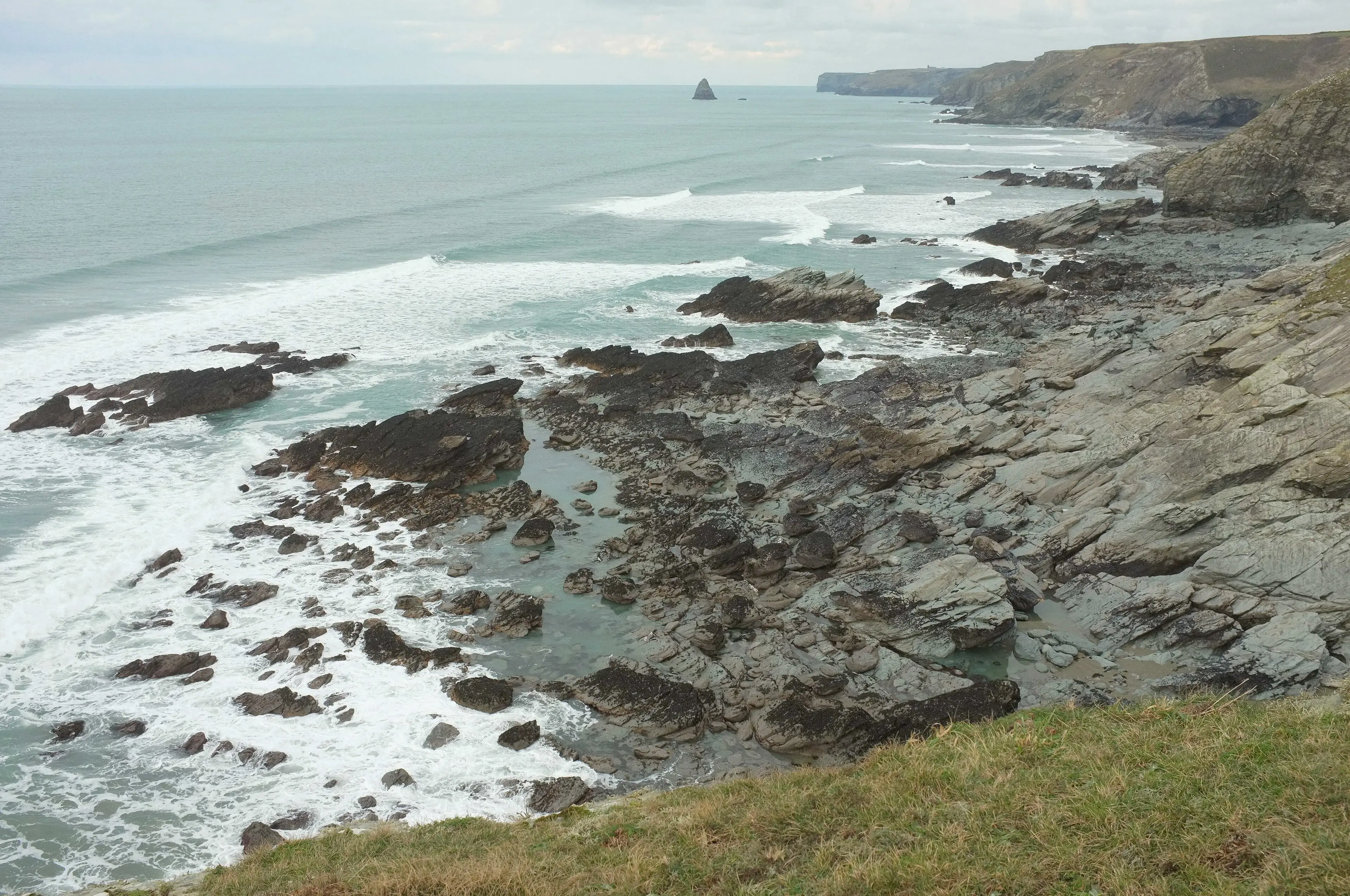 Waves breaking against the wave-cut platform at Jacket's Point on the north Cornwall coast.